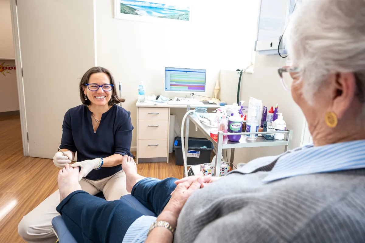 Podiatrist providing attentive foot care at the Noosa clinic